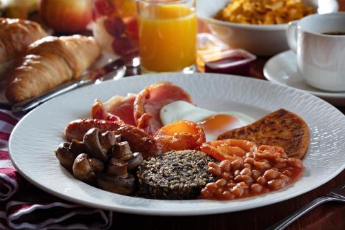 a plate of breakfast food on a table at Best Western Balgeddie House Hotel in Glenrothes