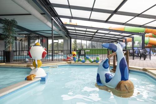 a pool at a resort with a water park at Camping ’t Veld in Rheeze