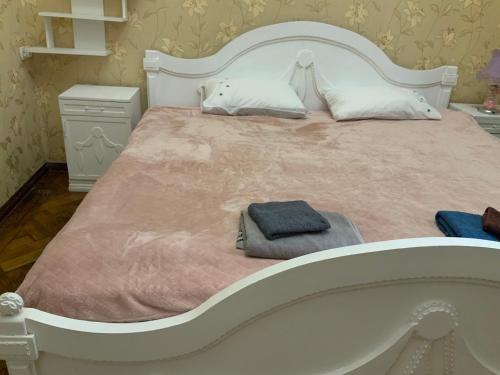 a large white bed with a blue towel on it at Український Театр 2-х кімнатні Апартаменти in Odesa