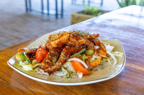 a plate of food with chicken on a table at Palmwag Lodge in Palm