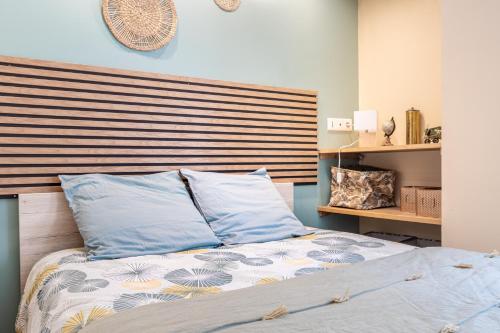 a bedroom with a bed with blue pillows at La suite de L'Evêché in Limoges