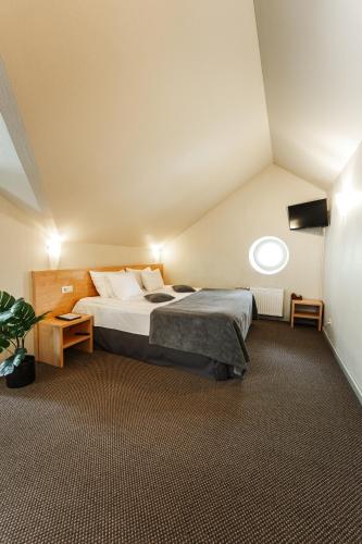 a bedroom with a large bed in a attic at Hotel Sigulda in Sigulda