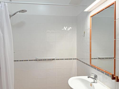 a bathroom with a sink and a mirror at Casa Formosinha Cabanas Beach in Cabanas de Tavira