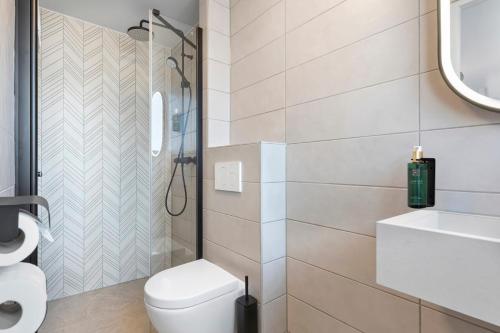 a bathroom with a toilet and a sink at Dutch Design Hotel Vondelpark in Amsterdam