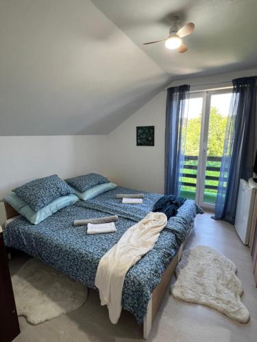 a bedroom with two beds and a window at Quiet Forest Retreat with Pool in Borovnica
