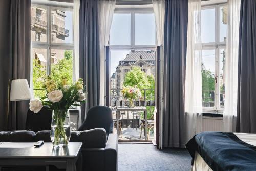 a hotel room with a large window and a living room at Crystal Plaza Hotel in Stockholm