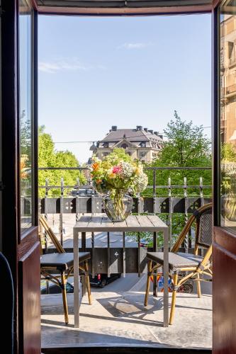 a table with a vase of flowers on a balcony at Crystal Plaza Hotel in Stockholm