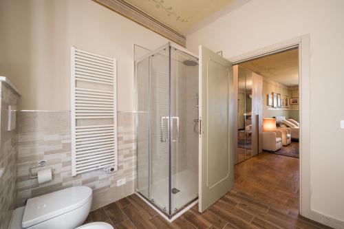 a bathroom with a toilet and a glass shower at Casa Ferdinanda in Monteleone dʼOrvieto