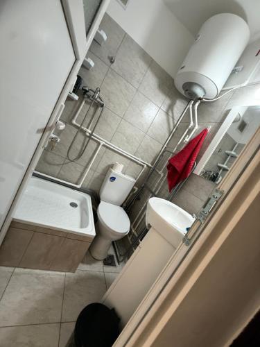 a small bathroom with two toilets and a sink at Luxury Apartament in Bacău