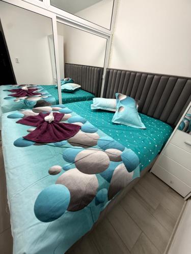a bedroom with two beds with a panda bear blanket at Luxury Apartament in Bacău