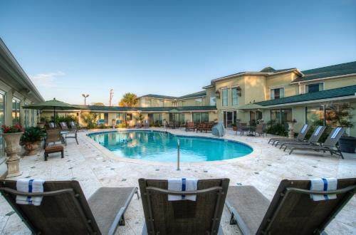 a large swimming pool in front of a large building at Town & Country Inn and Suites in Charleston