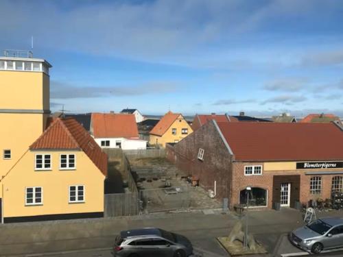 a view of a town with cars parked in a parking lot at Svanegade 1 , 2 sal in Thyborøn