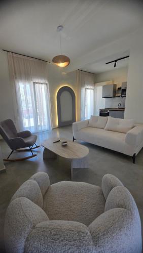 a living room with two couches and a coffee table at Inos Boutique Apartments in Skala Prinou