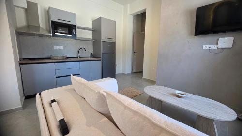 a living room with a couch and a table at Inos Boutique Apartments in Skala Prinou