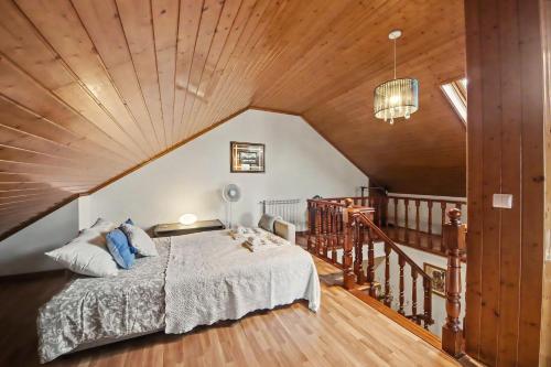 a bedroom with a bed and a wooden ceiling at Casa Na Aldeia in Arões