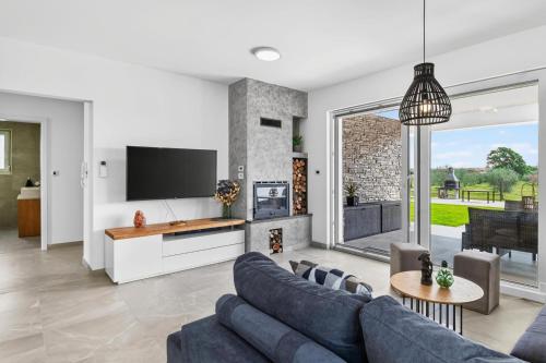 a living room with a couch and a tv at Villa Tea by Rent Istria in Umag