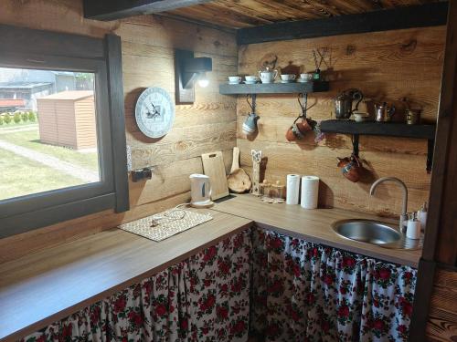 a kitchen counter with a sink and a window at Słoneczne Łąki in Wólka Soseńska