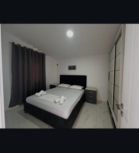 a bedroom with a bed with two towels on it at Martin Apartments in Gornji Štoj