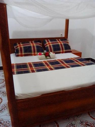 a bed with two pillows on top of it at Arham Nungwi Beach in Nungwi