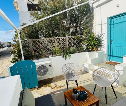 a patio with two chairs and a table at Beach House Batsi in Batsi