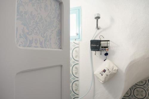 a bathroom with a shower with a hand towel at Sokaki Patmos in Skala