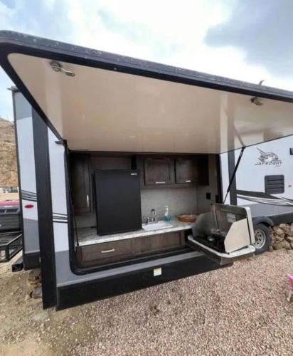 an rv with a kitchen and a sink in it at كرفان نور القمر in Al Namas