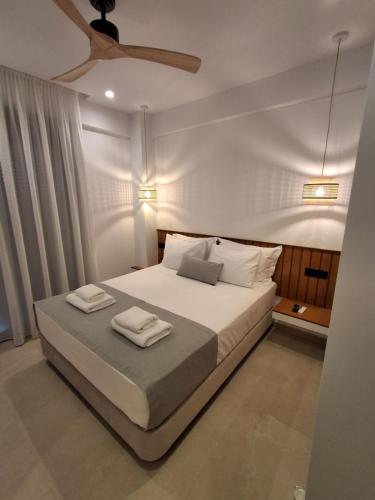 a bedroom with a bed with two towels on it at Salsedo Seaside Rooms 3 in Kanali