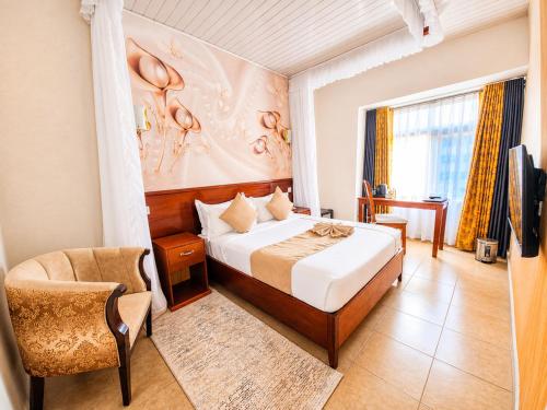 a hotel room with a bed and a chair at The Kyaka Hotel in Machakos