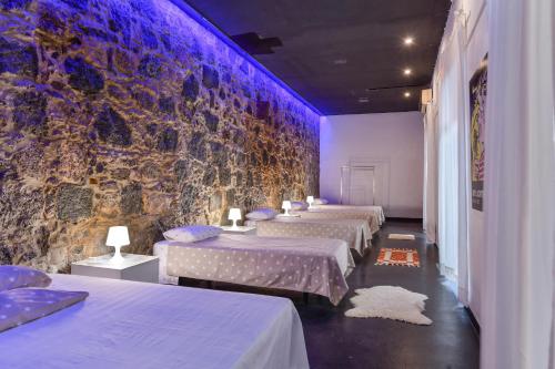 a row of beds in a room with purple lights at Brothers House in Arrecife