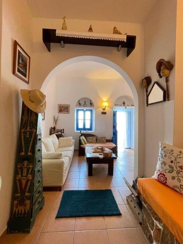 a living room with a couch and a table at Cycladic House with Aegean Sea View in Aegiali