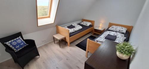 a small room with two beds and a table at Cottage in the middle of nowhere 2 in Ölfus