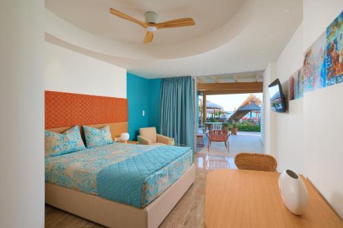 a bedroom with a bed and a ceiling fan at Aptera Beach in Amoudara Herakliou