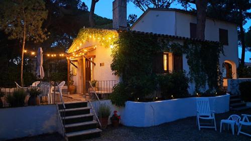 a white house with christmas lights on it at Calsina Baix 2H in Pals