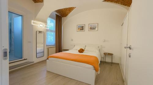 a bedroom with a bed with an orange blanket at Belvedere 237A Lakeview Luxury Apartment in Ghiffa