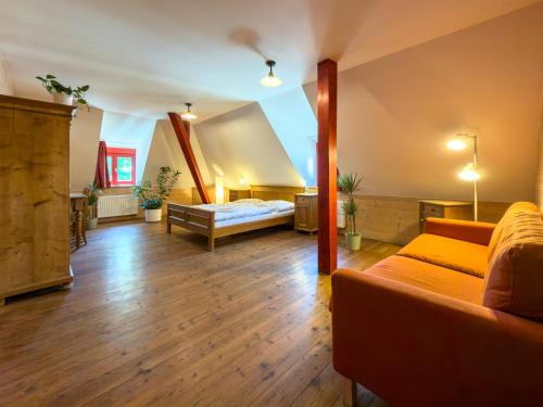 a large living room with a bed and a couch at Pivovarský hotel in Dalešice