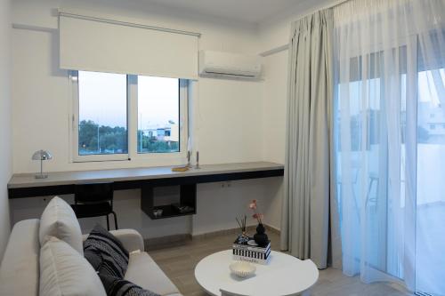 a living room with a white couch and a table at NEP APT Gennadi in Gennadi