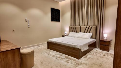 a bedroom with a bed with two candles on it at نزل ليلى الفندقية الفاخرة luxury in Abha