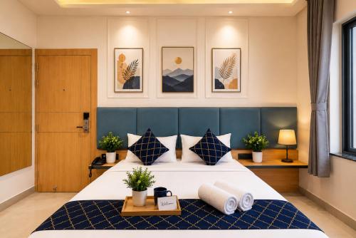 a bedroom with a large bed with a blue headboard at Hotel Shri Govindam Banaras with Parking in Varanasi