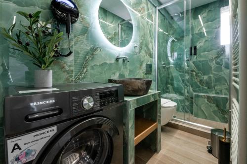 a washer and dryer in a bathroom with a shower at September15 Boutique Suites - Nikiana in Nikiana