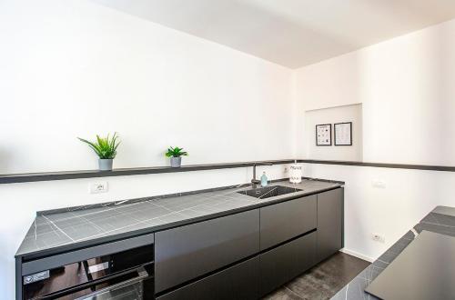 a kitchen with a sink and a counter at Lake Como with view, sauna and air conditioning in Mandello del Lario