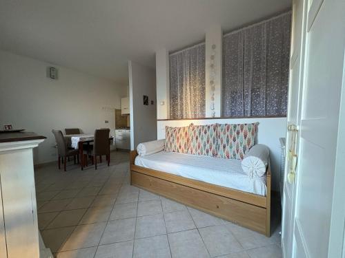 a bedroom with a bed and a dining room with a table at Alloggio turistico La casetta di Piazza Roma in Bracciano