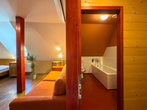 a room with two bunk beds and a tub at Pivovarský hotel in Dalešice