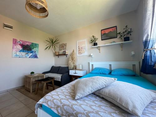 a bedroom with a blue bed and a couch at Studio Seaven, Lozenets in Lozenets