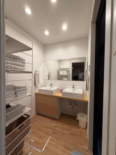a bathroom with two sinks and a large mirror at テラスKawazu in Kawazu