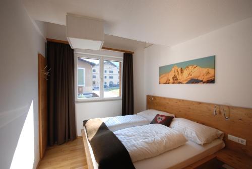 Posteľ alebo postele v izbe v ubytovaní EdelWeiss AlpinLodge