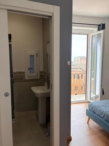 a bathroom with a sink and a toilet and a window at Eirenè Peaceful Suites in Agrigento
