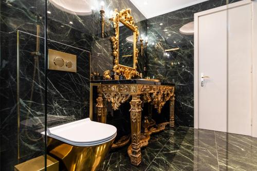 a bathroom with a gold sink and a mirror at Mythodea Luxury Villa Ι Sunset Horizon & Jacuzzi in Naxos Chora