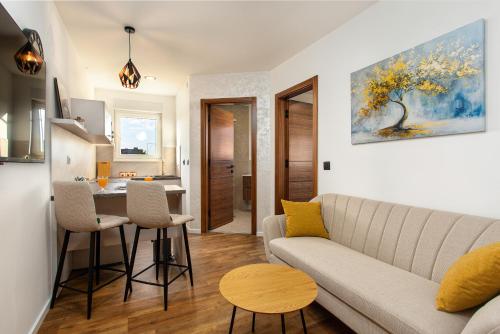 a living room with a couch and a table at Apartmani Ivano & Anđelo in Međugorje