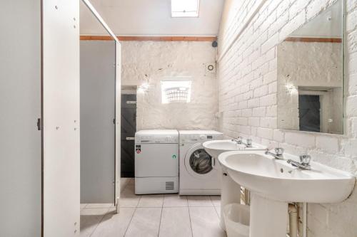 a bathroom with a washing machine and a washer and dryer at 4 Bed in Matlock oc-52094 in Highpeak Junction
