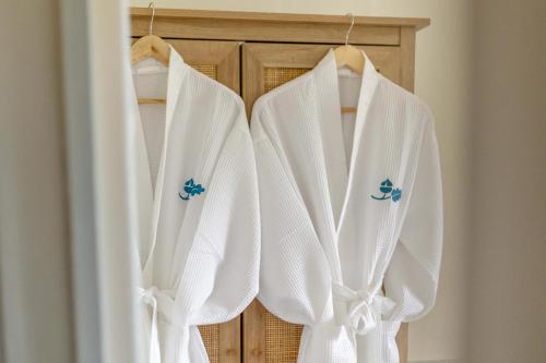 a group of white towels hanging on a closet at 3 Bed in Northrepps oc-k29801 in Cromer